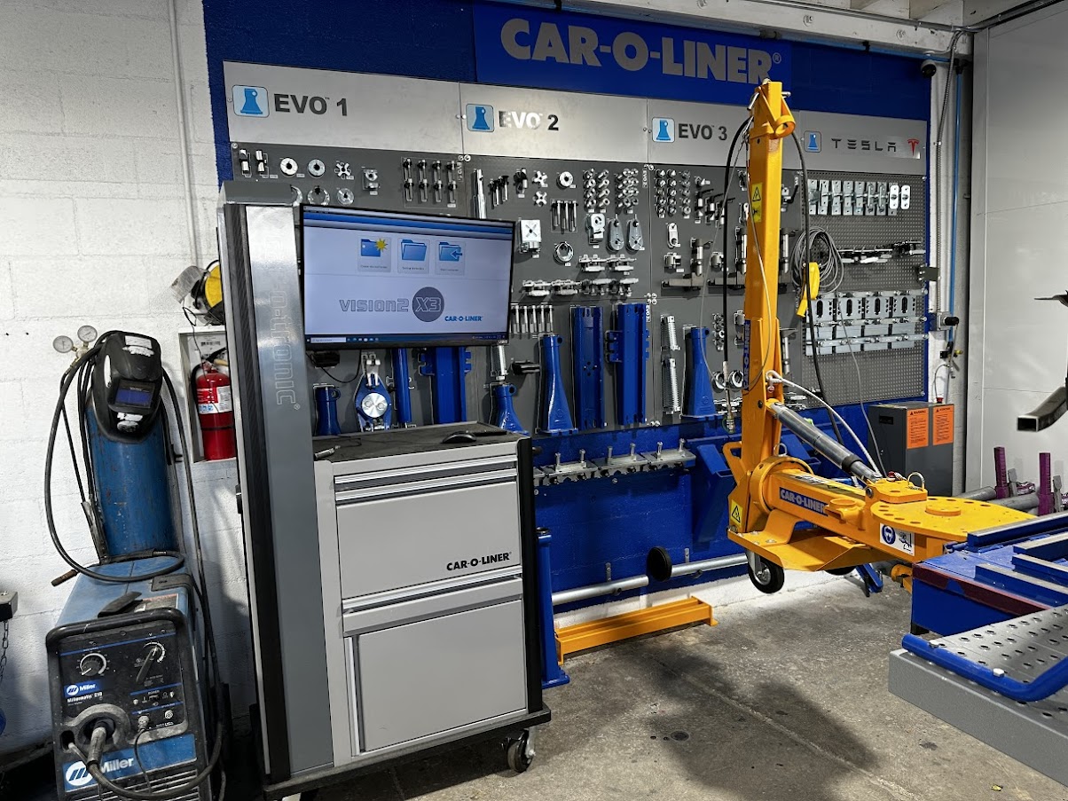 Collision repair workstation featuring the Car-O-Liner Vision X3 measuring system, EVO tools, and a dedicated Tesla fixturing kit.
