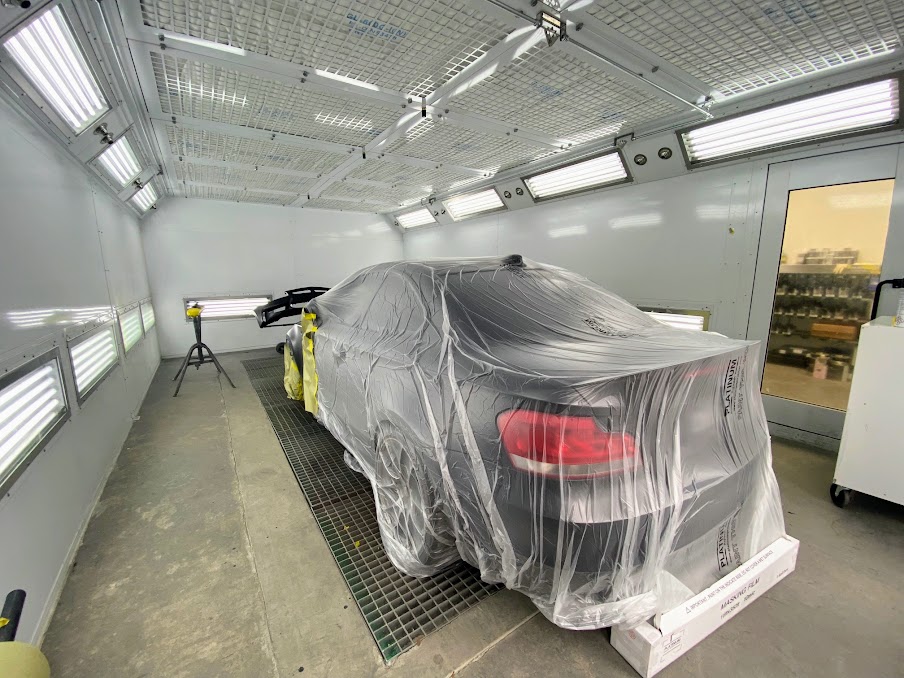 Vehicle covered and masked inside the US Auto Collision Center paint booth in Burbank